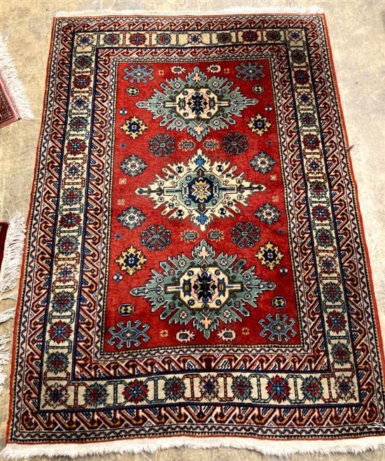 A Caucasian red and blue ground carpet, 158 x 108cm